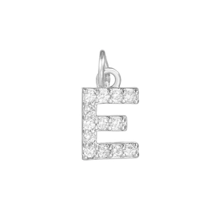 Macro shot of silver letter E pendant with 18k gold plating and micro-set zircons