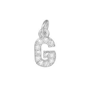 Macro shot of silver letter G pendant with micro-pave cubic zirconia for DIY jewelry making