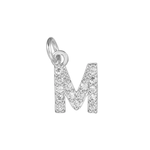 Macro shot of silver letter M pendant encrusted with micro-pave cubic zirconia stones