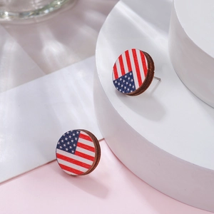 Detailed close-up of round wooden stud earrings featuring vibrant US flag pattern print