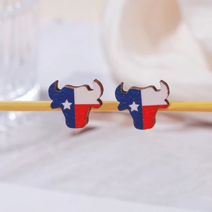 Detail of wooden bull head earrings featuring the Texas state flag on display