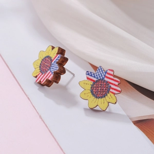 Detail of sunflower wood stud earrings featuring American flag patterns and metallic pins