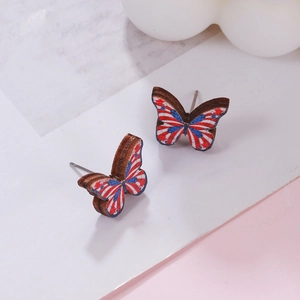 Detail of wooden butterfly earrings with American flag red white and blue stripe design
