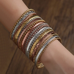 Close-up of bohemian stackable bangles set with ethnic patterns and hammered textures