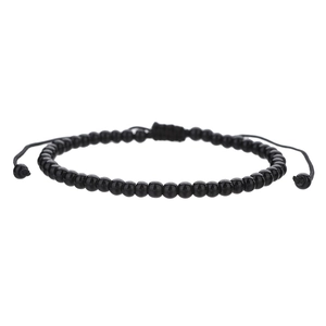 Close-up of black beaded bracelet with adjustable woven string and polished finish