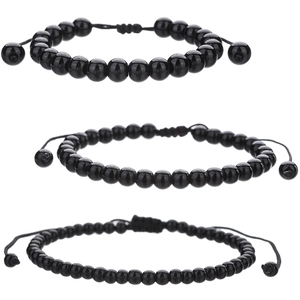 Three sizes of black stone beaded bracelets with adjustable braided cords on white background