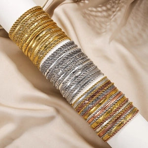 Macro shot of bohemian bangle set with textured gold and silver carved details