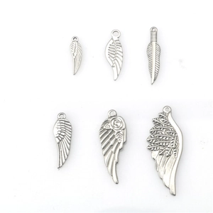 Set of six stainless steel wing and feather pendants with intricate engraved textures