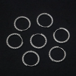 Set of six shimmering silver stainless steel hoop earrings with diamond-cut texture