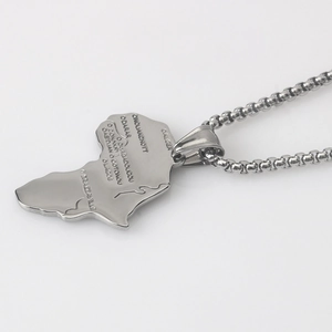 Detailed view of engraved Africa map pendant with city names on a bead chain