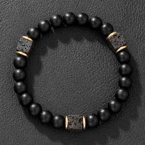 Matte black obsidian beaded bracelet with square lava stones on black leather background