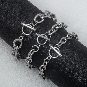 Unisex stainless steel punk OT buckle chain bracelet set on a black display stand
