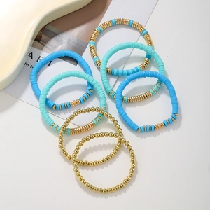 Detail of 7-piece bohemian heishi bead bracelet set with turquoise and gold accents