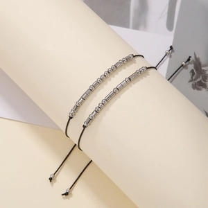 Detail of Morse code bracelet with silver beads and adjustable black woven cord