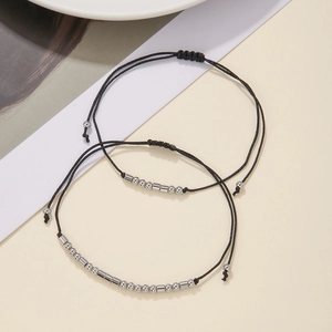 Set of two Morse code bracelets with black woven cords and adjustable silver metal beads