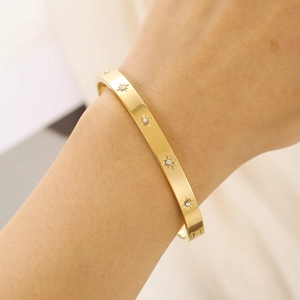 Gold titanium steel bangle with etched star patterns and sparkling zircon stones for women