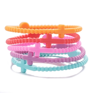 Close-up of five colorful silicone cross bracelets with beaded texture in a set