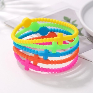 Close-up of five colorful silicone bead bracelets with Macaron cross charms
