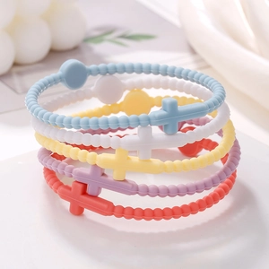 Set of five colorful silicone cross bracelets in macaron tones with beaded texture