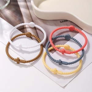 Silicone beaded cross bracelets in pastel macaron colors displayed on a white surface
