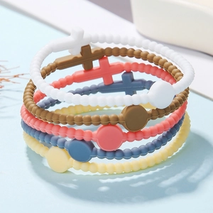 Macro detail of multi-color silicone cross bracelets in soft macaron tones for kids and adults