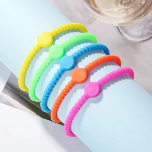 Detailed macro view of five colorful beaded silicone cross bracelets on a roll