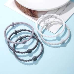 Detailed display of assorted silicone cross bracelets in pastel colors on a blue backdrop