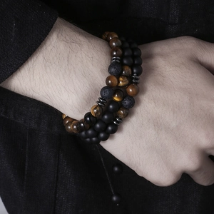 Three-piece men's beaded bracelet set featuring tiger eye, lava rock, and matte black stones