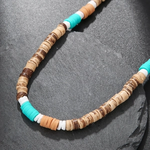 Bohemian wood and shell beaded necklace with colorful clay discs on dark stone base