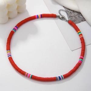 Detail of handmade colorful heishi bead necklace with red clay discs and lobster clasp