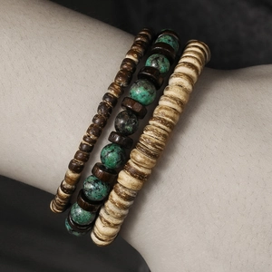 Detail of layered men's bracelet set with coconut shell wood beads and turquoise stones