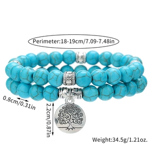 Detail of 8mm turquoise bead bracelet set featuring silver Tree of Life pendant and spacers