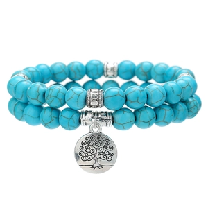 8mm turquoise bead bracelet set with silver tree of life charm on white background