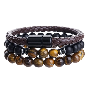 Detail of multi-layer men's bracelet with tiger eye stones and braided leather clasp