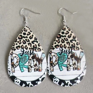 Detail of teardrop leather earrings featuring Just Pray text and leopard print patterns