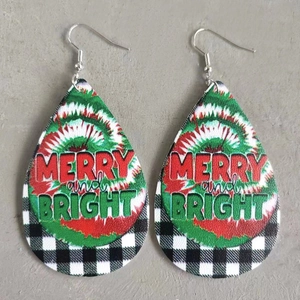 Detail of Christmas teardrop earrings with Merry and Bright print on buffalo plaid leather