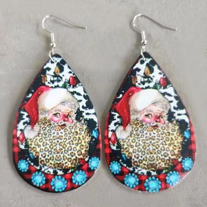 Macro detail of teardrop leather earrings featuring leopard beard Santa and floral patterns