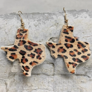 Detail of Texas map earrings featuring leopard print calf hair and golden hooks