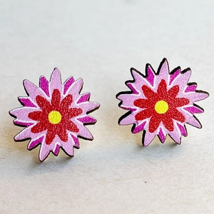 Macro shot of colorful layered floral earrings with vibrant red and pink petals