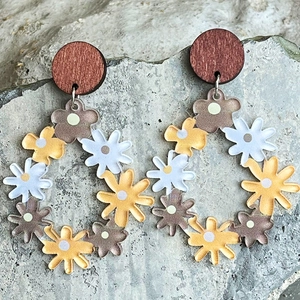 Bohemian daisy drop earrings with wood studs on grey stone background, floral design