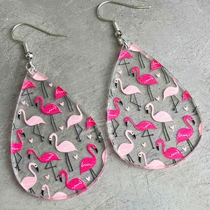 Acrylic teardrop earrings featuring pink flamingo patterns on a textured stone background