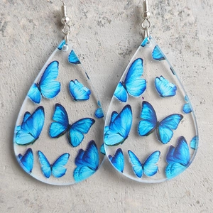 Blue butterfly print teardrop earrings made of transparent acrylic with silver metal hooks
