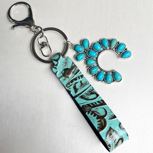 Western style leather keychain with turquoise cactus patterns and silver horseshoe charm