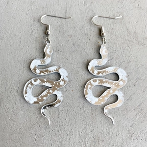 Floral snake-shaped acrylic earrings with celestial patterns and silver hooks