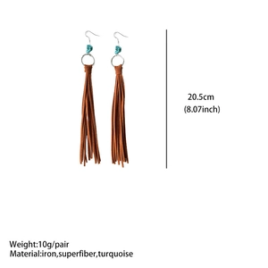 Detailed view of bohemian faux leather fringe earrings with turquoise beads and silver rings