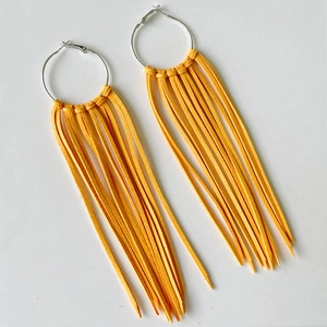Bohemian silver hoop earrings with bright yellow fringe tassels in Western cowboy style