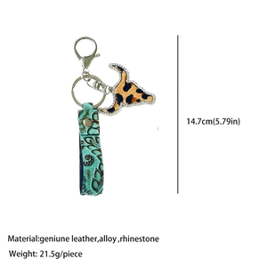 Detail of Western style cow skull keychain with turquoise embossed leather and rhinestones