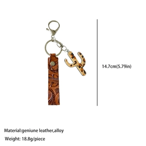Detail of genuine leather western keychain with embossed texture and leopard cactus charm