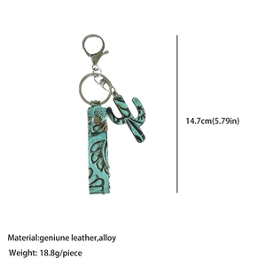 Detail of turquoise embossed leather cactus keychain with silver alloy clasp and ring