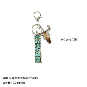 Detailed view of bull skull pendant and turquoise embossed leather keychain strap